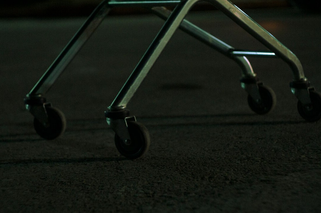 Camera on a dolly track moving across a dark set