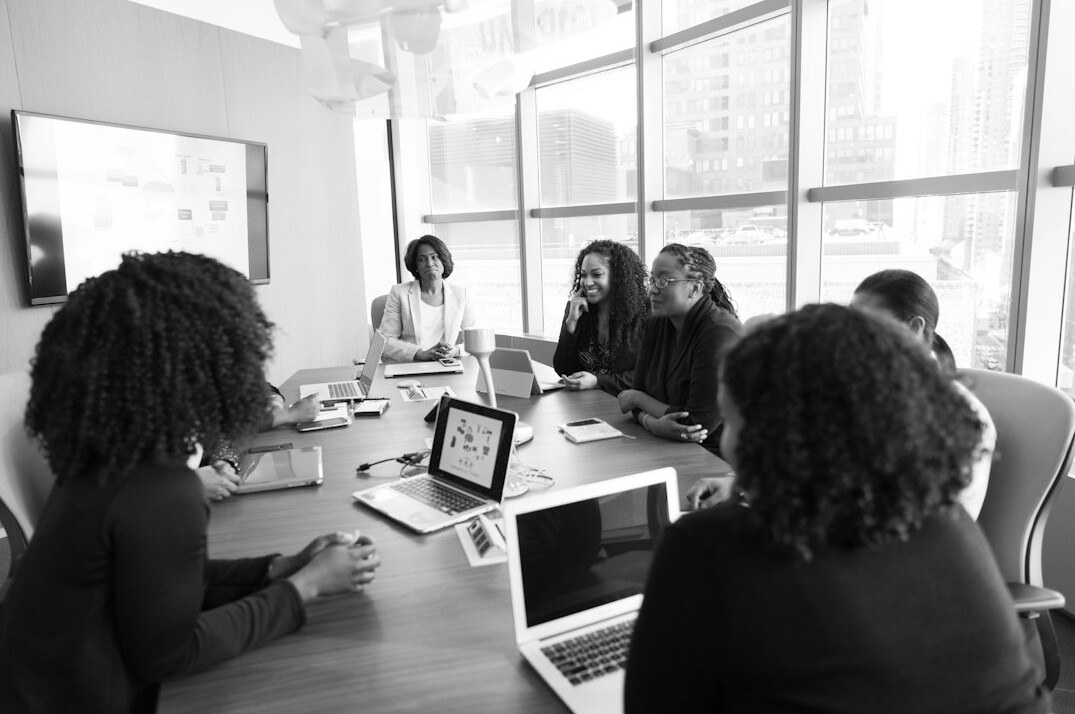 Colleagues collaborating at a table in a bright studio office